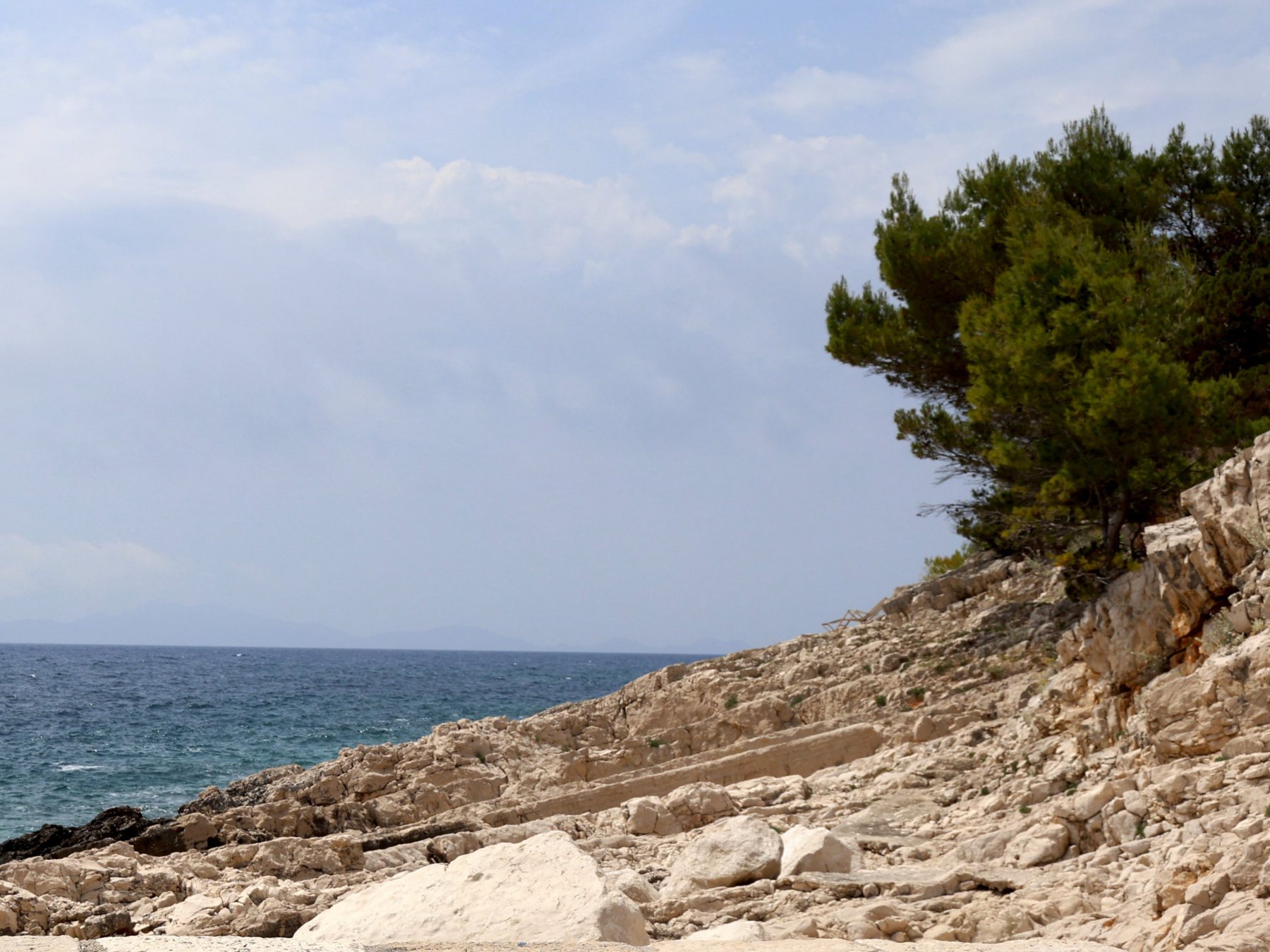 Pale limestone shore and pines above the open Adriatic on Korčula